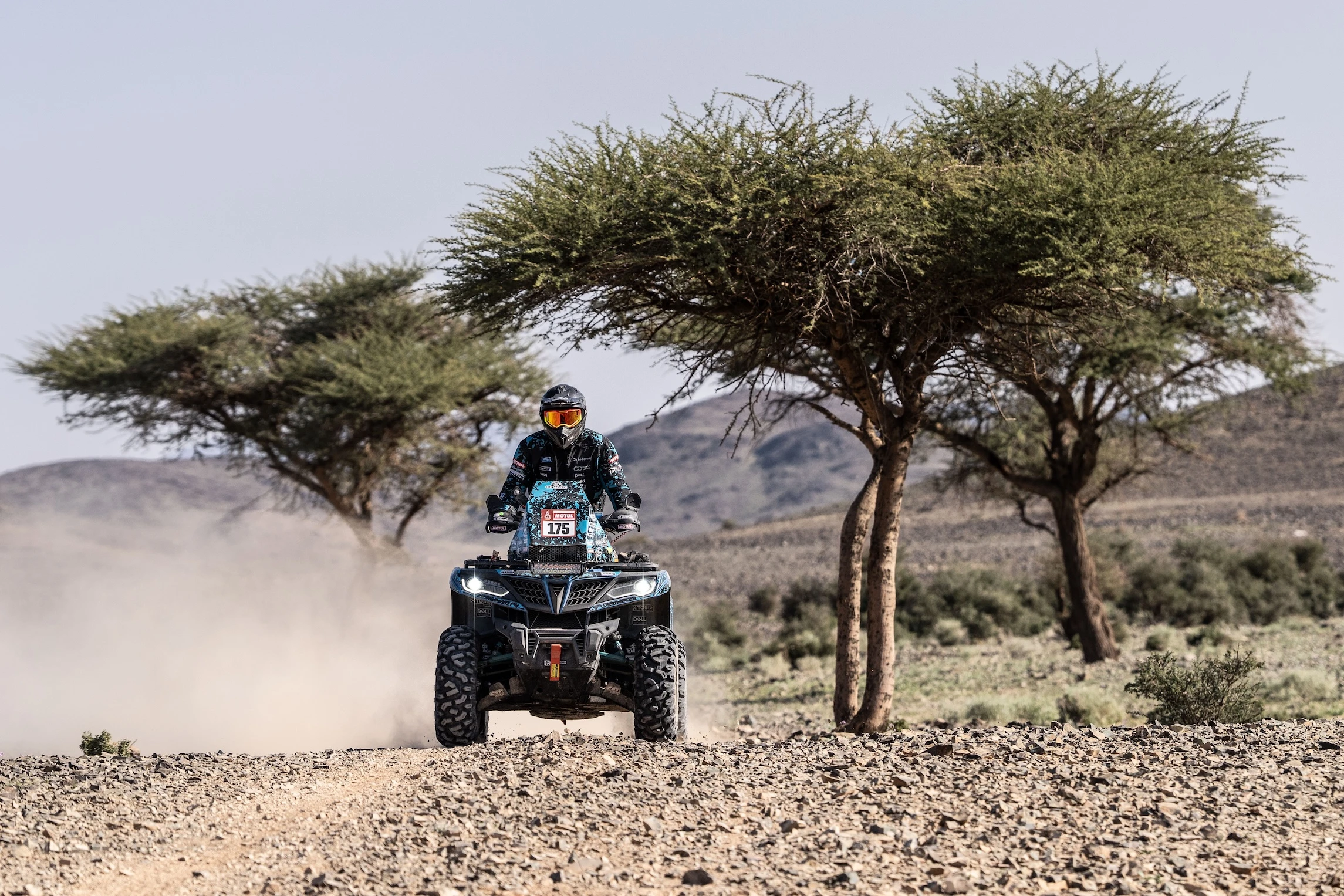 Monday in Saudi Arabia became another difficult challenge for the participants. Athletes not only had to overcome a speed stage of more than 438 kilometers and almost 300 km of liaison, but also to carefully protect their vehicles. The mechanics will only have two hours to repair it before tomorrow's start, so any major damage could have ended badly. CFMOTO Thunder Racing Team rider Antanas Kanopkinas reached the finish line successfully, but experienced much on the track. "It was a very difficult day. For the first hundred kilometers, I drove like I was carrying some egg basket - I was trying to protect the quad over the stony sections. After that it all went well, I had to dig a little sand in the dunes, but I lost maybe five minutes. Also lost the track a few times, but all the missteps cost a minute each, so basically everything went according to plan today. The most important thing is that we came back with light", A. Kanopkinas said in the service park and mentioned that he will go to the judges to ask why a two-hour penalty was added to his results. The athlete did not hide that there were dangerous moments on the track - there were dangerous hollows that were not marked in the road book. According to the preliminary results, A. Kanopkinas finished eighth in the quad classification today and laughed that the seven hours spent on the stage are becoming a casual routine. Tonight, athletes will sleep in tents provided by the organizers, separate from their teams. It is part of the first marathon stage of this Dakar Rally. Tomorrow, the participants will have to cover a total of 631 kilometers, of which 299 will be the speed stage. Organizers say there will be fast sections, but also challenging navigational challenges.