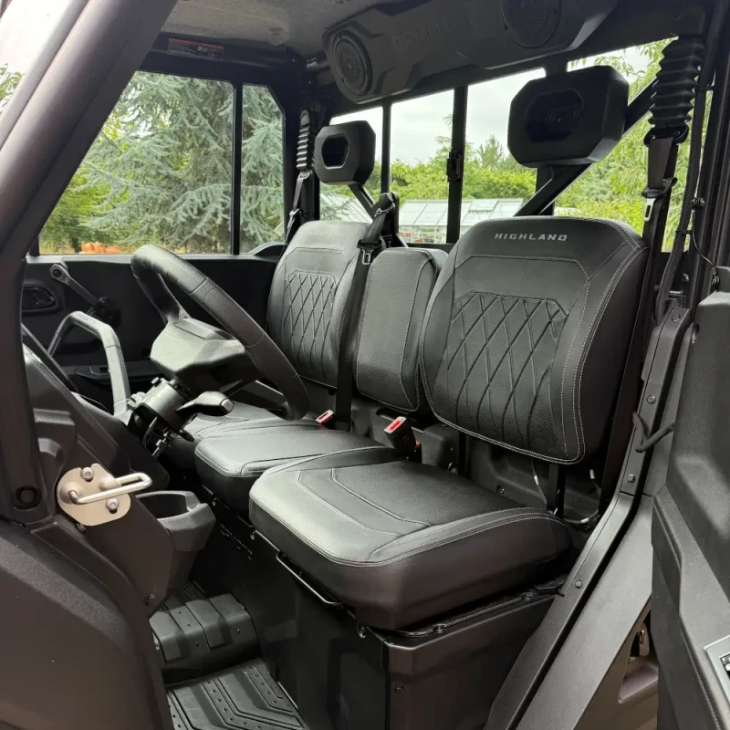 U10 Pro Highland interior Two black leather front seats with "HIGHLAND" branding inside the UFORCE U10 PRO, showing the steering wheel, dashboard, and seat belts.